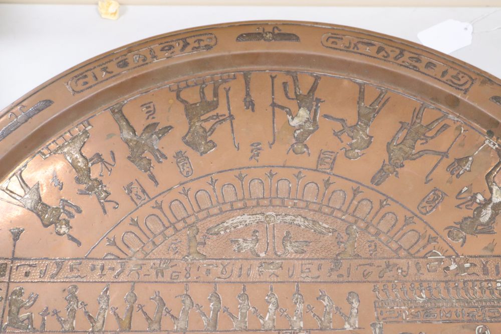A large circular copper tray with white metal inlay depicting ancient Egyptian scenes, diameter 61cm
